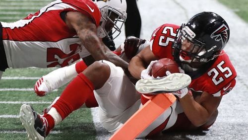 Falcons running back Ito Smith is stopped just short of the endzone by Cardinals Brandon Williams during the first half in a NFL football game on Sunday, Dec 16, 2018, in Atlanta.   Curtis Compton/ccompton@ajc.com