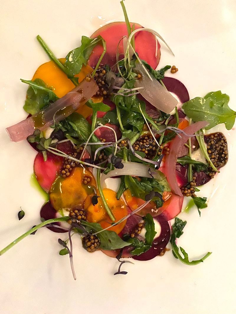 The Dining Room offers three- and four-course tasting menus developed by executive chef and culinary director Ryan Caldwell. Pictured is a recent first-course of beetroot carpaccio with pickled mustard and fresh arugula. Ligaya Figueras / ligaya.figueras@ajc.com