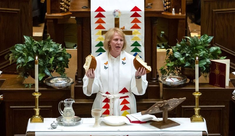 Bishop Sue Haupert-Johnson prays over a lof of bread before communion is served Sunday at the St. Mark United Methodist Church in Atlanta March 3, 2019. STEVE SCHAEFER / SPECIAL TO THE AJC