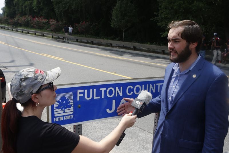 Laura Loomer does an interview alongside State Rep. Colton Moore as other  supporters protest outside of the Fulton County Jail the day Trump plans to be booked on Thursday, August 24, 2023 in Atlanta. (Michael Blackshire/Michael.blackshire@ajc.com)