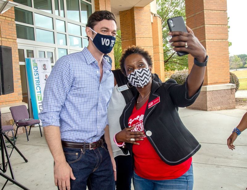 Backers of Democratic U.S. Senate candidate Jon Ossoff, shown posing for a photograph at a rally this month at the New Birth Missionary Baptist Church in Stonecrest, say his fundraising abilities could carry him to a victory in November. So far, the combined campaign spending by Ossoff, his opponent, Republican U.S. Sen. David Perdue, and their outside supporters has totaled more than $125 million.  STEVE SCHAEFER / SPECIAL TO THE AJC 