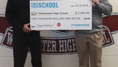 Chris Milewski (left), market development manager for Coca-Cola, presented Whitewater’s athletic director, Mike Vena, with a $2,000 grant for the school’s sports programs. Courtesy Fayette County Board of Education