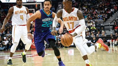 Atlanta Hawks guard Dennis Schroder (17) tries to get past Charlotte Hornets guard Brian Roberts (22) during the first half of an NBA basketball game, Tuesday, April 11, 2017, in Atlanta. (AP Photo/John Amis)