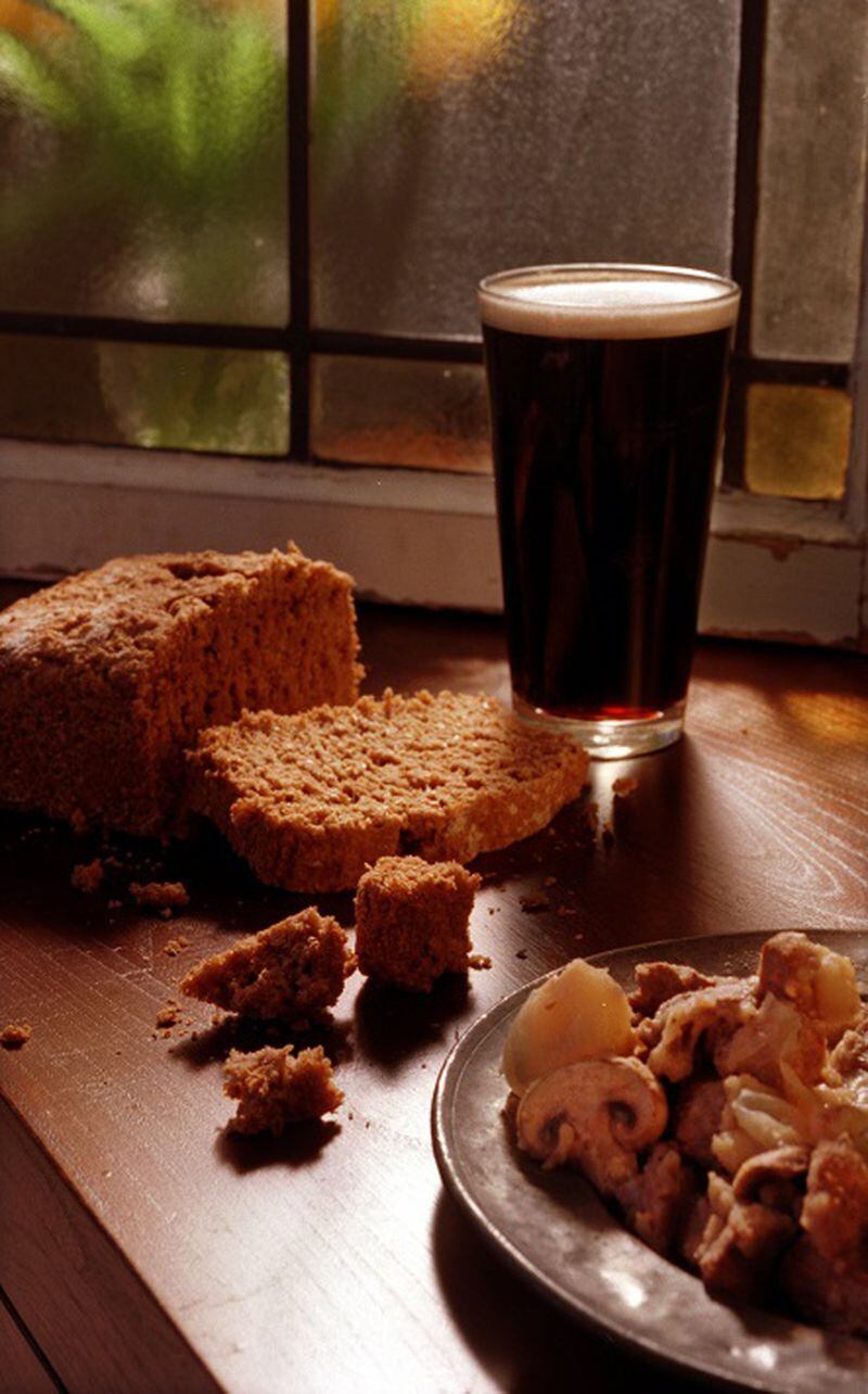 In a 1999 file image, a glass of stout, bread and lamb stew. Guinness, Ireland's most famous stout, gives this lamb stew its deep flavor. Pair it with some bread for a hearty dinner. (Susan Tusa/Detroit Free Press/TNS)
