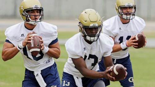 Georgia Tech quarterbacks from left, Lucas Johnson, Jay Jones and Matthew Jordan run a drill during an NCAA college football practice in Atlanta, Monday, March 27, 2017. Coming off a nine-win season, Georgia Tech begins spring football practice Monday with all eyes on the quarterback position after the departure of three-year starter Justin Thomas. (AP Photo/David Goldman)