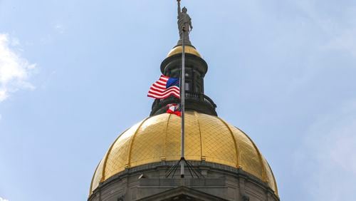 July 11, 2019  Atlanta : The United States and State of Georgia flags flew half-staff at the Georgia State Capitol on Thursday July 11, 2019 after Governor Kemp signed an executive order in memory of Hall County deputy Nicolas Dixon who was shot and killed. JOHN SPINK/JSPINK@AJC.COM