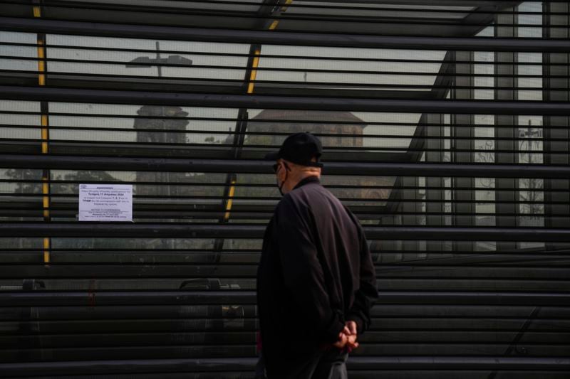 A man reads a sign informing passengers about the strike, in a metro station, in the Egaleo suburb of Athens, on Wednesday, April 17, 2024. The General Confederation of Greek Labor, GSEE, called the strikes to press for a return of collective bargaining rights axed more than a decade ago during a severe financial crisis. The 24-hour strike kept ferries at ports and disrupted other public services, leaving some state-run hospitals running on emergency staff levels (AP Photo/Petros Giannakouris)