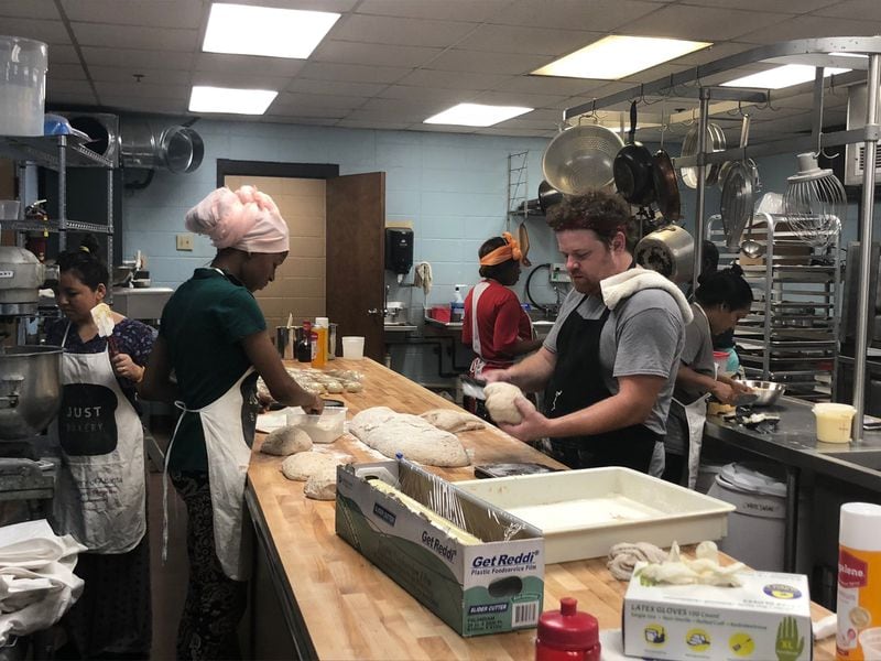 A long work table topped with butcher block provides space for head baker and educator Mike Carmody and his bakers-in-training to form multigrain loaves and Gruyere pretzels. CONTRIBUTED BY JUST BAKERY OF ATLANTA