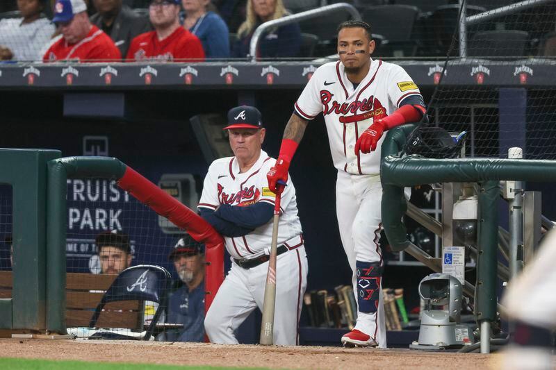 Atlanta Braves manager Brian Snitker, left, and Orlando Arcia watch as Atlanta Braves’ Ozzie Albies (not pictured) bats during the ninth inning against the Los Angeles Dodgers at Truist Park, Tuesday, May 23, 2023, in Atlanta. The Dodgers won 8-1. (Jason Getz / Jason.Getz@ajc.com)