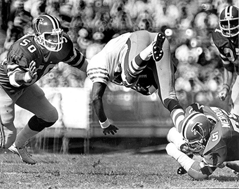Falcons linebacker Greg Brezina (50) is there to clean up San Francisco 49ers running back Bob Ferrell, who is tripped up coming through the line of scrimmage in 1978. (AJC)