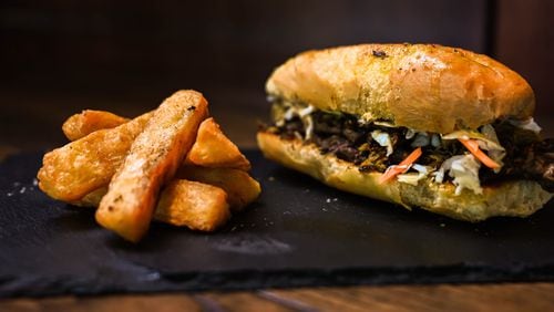 Taking inspiration from a Cuban sandwich, Zeke's offers one with Haitian components: epis-marinated pork and brisket, pikliz and an epis aioli. Courtesy of Zeke's Kitchen and Bar