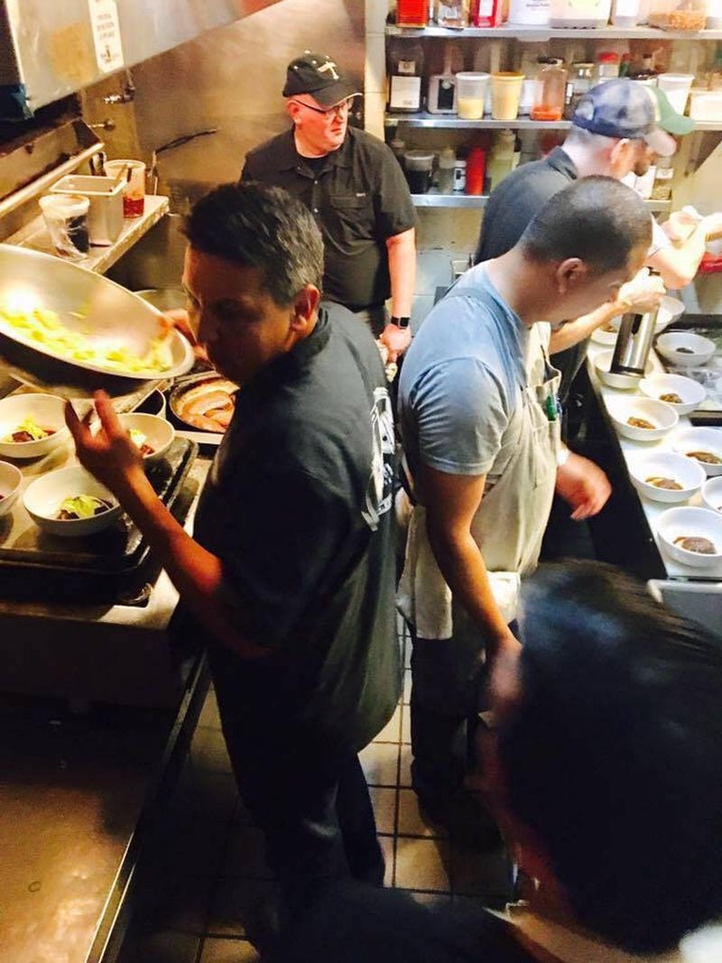 Steinbeck's boasts one of the smallest kitchens in metro Atlanta. Here, its executive chef Andy Gonzales (front left), works the line for the restaurant's 10th anniversary dinner in 2017 alongside (from left) chefs Doug Turbush,
Sam Herndon, Brendan Keenan and George Yu.