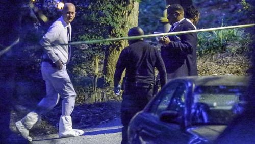Crime scene investigators are looking into a home invasion and shooting that injured four people on Thurs., July 14, 2016 in DeKalb County. JOHN SPINK / JSPINK@AJC.COM