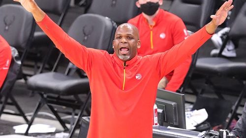 Hawks interim head coach Nate McMillan tries to get his players' attention on defense against the Milwaukee Bucks.   “Curtis Compton / Curtis.Compton@ajc.com”