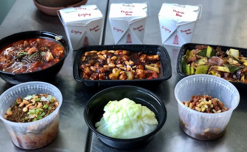 This takeout order from Urban Wu includes: (clockwise from upper left) braised fish in chili oil, kung pao chicken, Sichuan double-cooked pork, lettuce wraps and dan dan noodles. CONTRIBUTED BY WENDELL BROCK