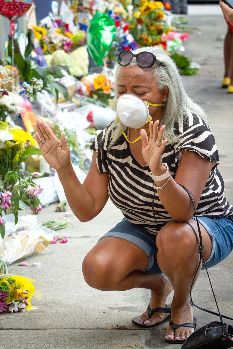 Delilah Davis kneels and prays at the John Lewis memorial on Auburn Ave, Sunday, July 19, 2020.  STEVE SCHAEFER FOR THE ATLANTA JOURNAL-CONSTITUTION