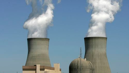 Steam rises from the cooling towers of nuclear reactors at Georgia Power’s Plant Vogtle in Waynesboro. Construction of two new reactors at the site is now more than $3 billion over budget and more than three years behind its original schedule. (AP Photo/Mary Ann Chastain, File)