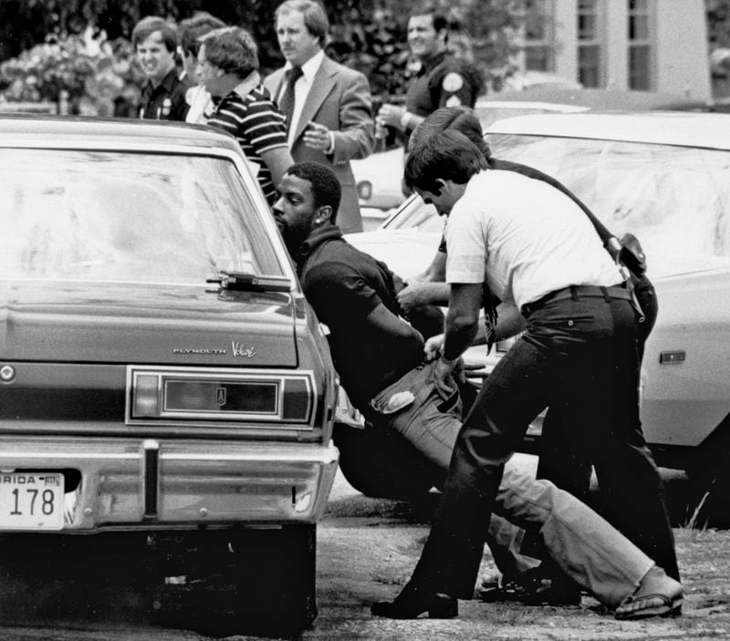 FILE - Police handcuff a suspect during a drug raid in Miami, May 18, 1979. Police said eight were arrested and marijuana was seized. Marijuana advocates are gearing up for Saturday, April 20, 2024. Known as 4/20, marijuana's high holiday is marked by large crowds gathering in parks, at festivals and on college campuses to smoke together. This year, activists can reflect on how far the movement has come. Medical marijuana is now legal in 38 states. (AP Photo/Al Diaz, File)