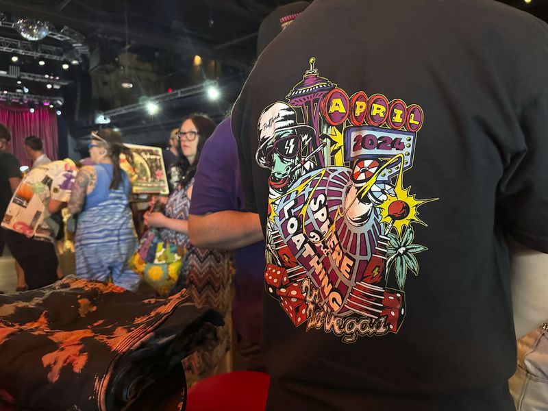 This photo during PhanArt shows a Hunter S. Thompson-inspired "Sphere and Loathing in Las Vegas" shirt created by artist Sean Marmora on Saturday, April 20, 2024, at the Brooklyn Bowl in Las Vegas. The shirt is in celebration of Phish's four-night residency at the Sphere. (AP Photo/Josh Cornfield)