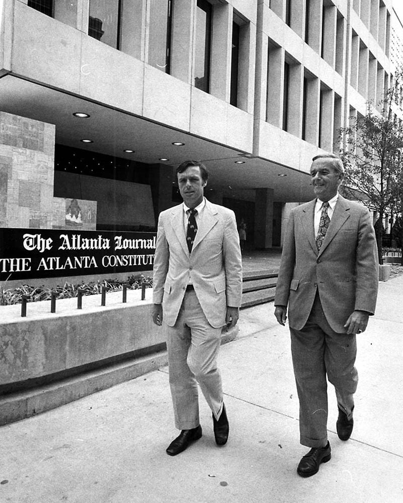Constitution Editor Reg Murphy, left, walks with Journal Editor Jack Spalding in front of the 72 Marietta Street building. (Dwight Ross, Jr., AJC file)