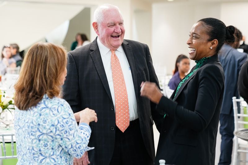 Sonny Perdue, the new chancellor of the University System of Georgia, shares a laugh during a luncheon following the inauguration of Georgia Gwinnett College President Jann L. Joseph, Friday, April 1, 2022, in Lawrenceville.  Friday was the first day at work for Perdue, the former two-term Georgia governor.  (Elijah Nouvelage/Special to the Atlanta Journal-Constitution)