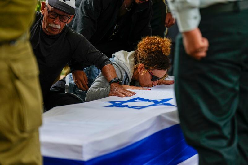 Ami Aviv mother of Israeli reserve soldier Master sergeant Ido Aviv kisses his casket during his the funeral in Carmiel, northern Israel, Tuesday, April 30, 2024. Aviv, 28, was killed during Israel's ground operation in the Gaza Strip, where the Israeli army has been battling Palestinian militants in the war ignited by Hamas' Oct. 7 attack into Israel. (AP Photo/Ariel Schalit)