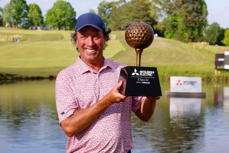 Stephen Ames shows the trophy to the media after winning the Mitsubishi Classic senior golf tournament at TPC Sugarloaf on Sunday, April 28, 2024, in Duluth, Ga. (Miguel Martinez/Atlanta Journal-Constitution via AP)