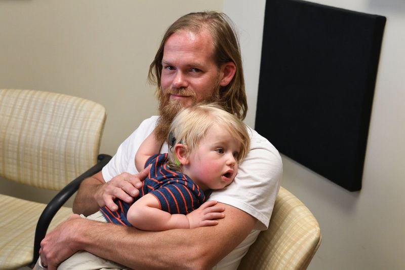 At first, Randy Adams was against the idea of cochlear implants for his son, Max, who’s now 16 months old, but eventually, he agreed — and wound up getting the procedure, too. CONTRIBUTED BY JACK KEARSE / EMORY UNIVERSITY