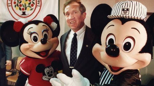 Minnie Mouse and Mickey Mouse are on hand as Tech coach Bobby Ross accepts a spot in the Citrus Bowl in 1990. Walter Stricklin / AJC
