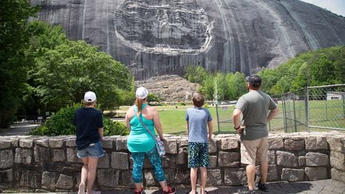 A family looks at the Confederate Memorial Carving at Stone Mountain Park Sunday, May 17, 2020.  STEVE SCHAEFER FOR THE ATLANTA JOURNAL-CONSTITUTION