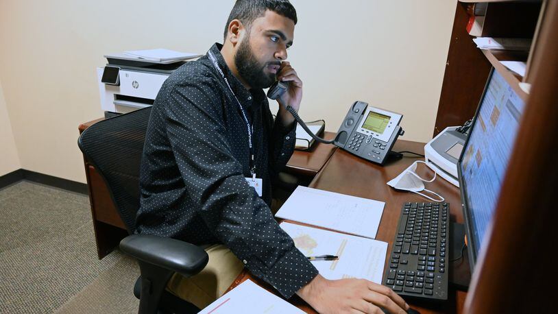 Epidemiologist Curtis Sarkar checks in via phone at Gwinnett Board of Health Administration Center in Lawrenceville on May 7, 2020. Georgia is beefing up its contact tracing program with the hope that it can tamp down on community spread. But contact tracing has limitations, especially as new cases spike. (Hyosub Shin / Hyosub.Shin@ajc.com)