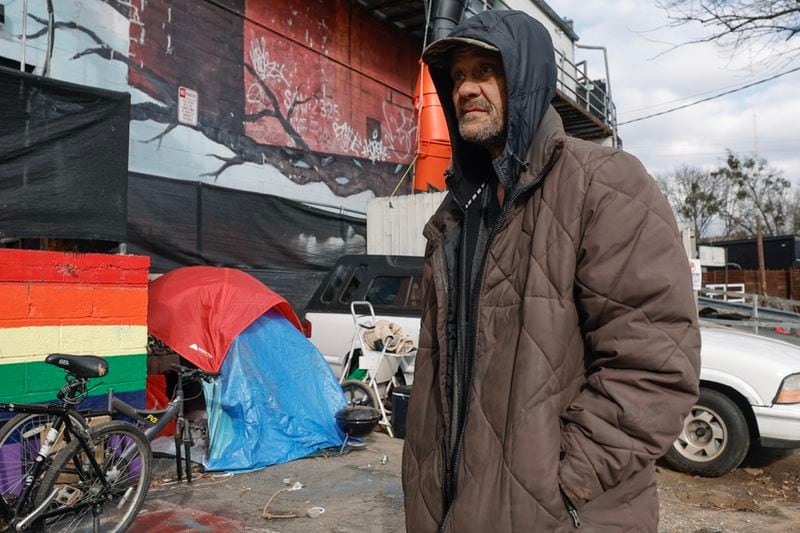 Will Bittler, who said he worked for decades as an electrician and has been homeless for about five months, stands near his tent behind a building on Cheshire Bridge Road in Atlanta on Friday, December 29, 2023. (Natrice Miller/ Natrice.miller@ajc.com)