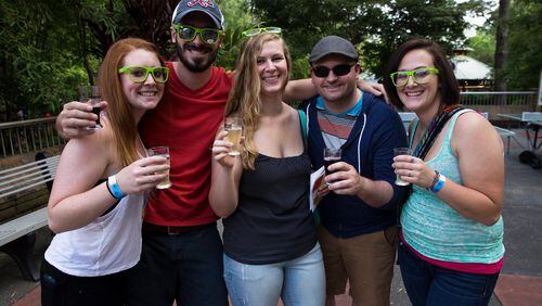 Atlantans smile for the camera with their brews at a previous Brew at the Zoo event.