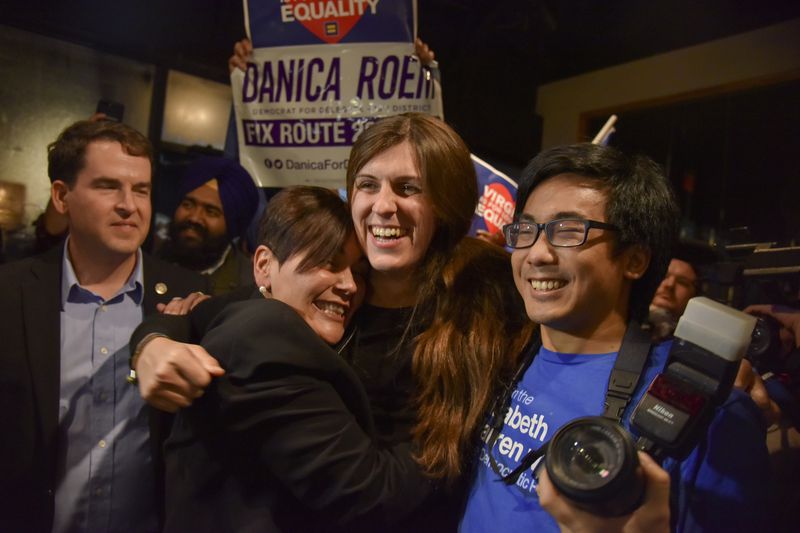 Danica Roem, center, who ran for house of delegates against GOP incumbent Robert Marshall, is greeted by supporters as she prepares to give her victory speech with Prince William County Democratic Committee at Water's End Brewery on Tuesday, Nov. 7, 2017, in Manassas, Va. Roem will be the first openly transgender person elected and seated in a state legislature in the United States.