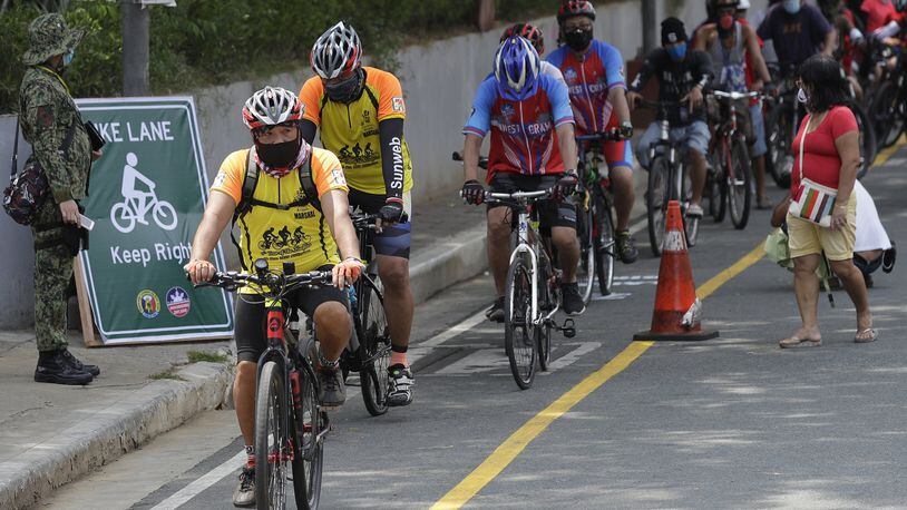 Cyclists wearing protective masks on a newly opened bicycle lane in Manila, Philippines in observance of World Bicycle Day on Wednesday, June 3, 2020. Several cities opened bicycle lanes as people use different ways of commuting while public transport remains limited during a more-relaxed lockdown to prevent the spread of coronavirus. (AP Photo/Aaron Favila)