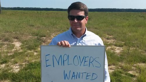 Trip Tollison is one of the state and local salesmen trying to land a big one for the Pooler site. (We talked him in to holding the sign.)