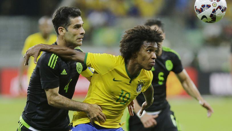 Mexico’s Rafael Marquez (left) fights for the ball with Brazil’s Willian during a friendly soccer match in Sao Paulo, Brazil, Sunday, June 7, 2015. The Mexico team will play in the Georgia Dome yet again, this time on May 28 as a warmup for the Copa American Centenario. (AP Photo/Nelson Antoine)
