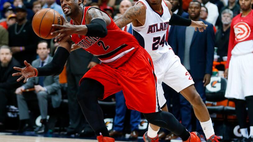 Portland Trail Blazers guard Wesley Matthews (2) is fouled by Atlanta Hawks guard Kent Bazemore (24) as he drives to the basket during the second half of an NBA basketball game Friday, Jan. 30, 2015, in Atlanta. Atlanta won 105-99 and stretched its winning streak to 18. (AP Photo/John Bazemore)