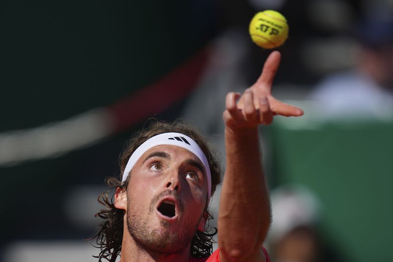 Stefanos Tsitsipas of Greece serves to Casper Ruud of Norway during their Monte Carlo Tennis Masters final match in Monaco, Sunday, April 14, 2024. (AP Photo/Daniel Cole)