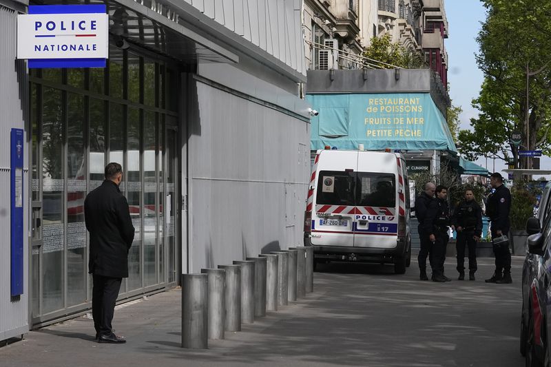 Police officers stand outside the police station where French actor Gerard Depardieu is expected to be questioned, Monday, April 29, 2024 in Paris. French media are reporting that police have summoned actor Gérard Depardieu for questioning about allegations made by two women that he sexually assaulted them on movie sets. (AP Photo/Michel Euler)