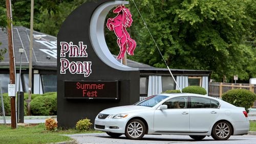 At the Pink Pony strip club, cold beer, shots and high balls tend to be the most popular beverages while customers watch nude women pole-dance. AJC FILE