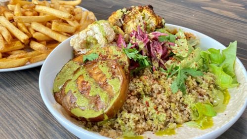 The rotisserie cauliflower and fried eggplant bowl, with a side of fries, at the Daily Chew.
Wendell Brock for The Atlanta Journal-Constitution