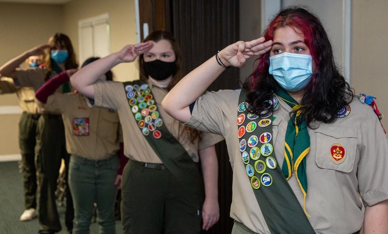 Veronica Roark (left) & Zoe Rosenberg salute during opening ceremonies at their troop meeting at the Roswell United Methodist Church scout hut in Roswell. The two are part of the all-girls Scout Troop 432, that meets at the church on Thursday nights. They are the first girls in the Northern Ridge Scout District to earn the Eagle Scout rank, and are among the nation's Inaugural Class of Female Eagle Scouts. PHIL SKINNER FOR THE ATLANTA JOURNAL-CONSTITUTION.