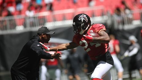 Atlanta Falcons running back Devonta Freeman (24) runs the ball during open practice  Sunday, July 29, 2018, at Mercedes-Benz Stadium in Atlanta.
