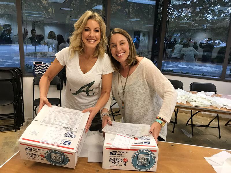  Kristin Klingshirn, who has had several family members in the military, joins long-time volunteer Jen Angier to help pack up letters. CREDIT: Rodney Ho/rho@ajc.com