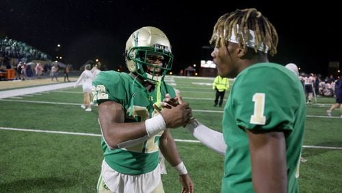 090222 Buford, Ga.: Buford running back Justice Haynes (22) celebrates with wide receiver K.J. Bolden (1) after their 21-14 win against North Cobb at Tom Riden Stadium, Friday, September 2, 2022, in Buford, Ga. Haynes accounted for all three of Buford’s touchdowns. (Jason Getz / Jason.Getz@ajc.com)