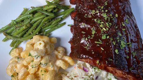 Big Oak Tavern family meal with baby back ribs, coleslaw, macaroni and cheese, green beans, and dinner rolls. 
Bob Townsend for the Atlanta Journal-Constitution.