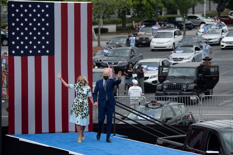 President Joe Biden and first lady Jill Biden arrive for a drive-in rally last month at Infinite Energy Center in Duluth. A new Atlanta Journal-Constitution poll shows about 60% of respondents approve of his handling of the coronavirus pandemic. (Brendan Smialowski/AFP/Getty Images/TNS)