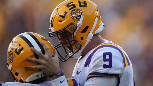 LSU quarterback Joe Burrow celebrates with a teammate during Oct. 26, 2019, matchup against the Auburn Tigers at Tiger Stadium in Baton Rouge, La.