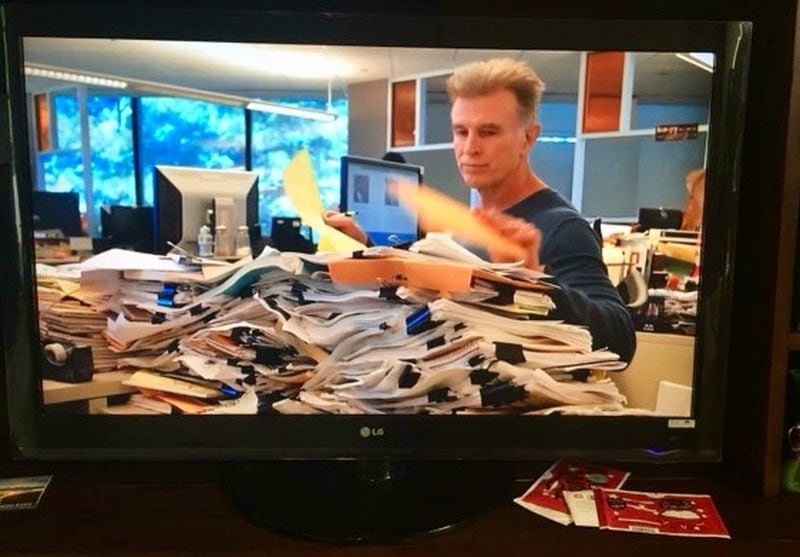 Bill Torpy calls this, “My stuff and me on the TV.” When The Atlanta Journal-Constitution did a TV advertising campaign, they shot a bunch of photos of reporters — including one of Torpy working behind his piles of government reports, lawsuit documents and reporter notebooks — to show how hard journalists work.